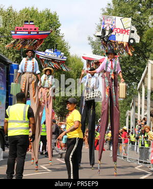 London, UK - August 27, 2018:  Notting Hill Carnival Colorful stilt walkers dancing Stock Photo