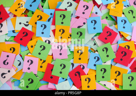 Too Many Questions. Big pile of colorful paper notes with question marks. Closeup. Stock Photo