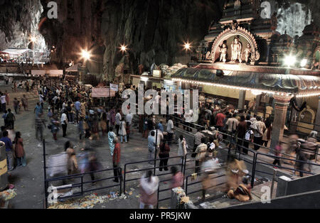 Hindu devotees worship inside Batu Caves temple during Thaipusam festival in Selangor, Malaysia Stock Photo