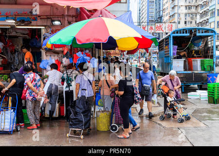 Hong Kong - July  05, 2018: People Buying Food At Market In Mong Kok Stock Photo