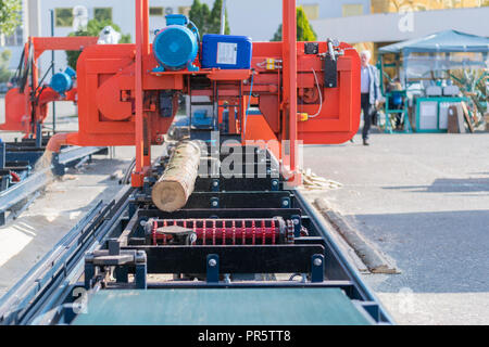 Partially milled log on a portable lumber milling machine Stock Photo