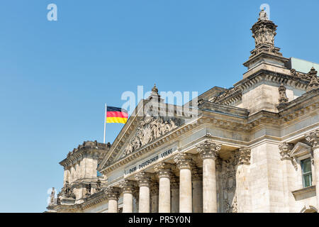 Closeup view of famous Reichstag building with German flag, seat of the German Parliament. Berlin Mitte district, Germany. Stock Photo