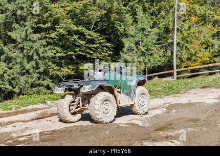 dirty atv quad bike in Carpathian Mountains, Western Ukraine Stock Photo