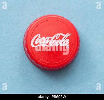 Bratislava, SLOVAKIA- APRIL 2018: Illustrative picture of Coca Cola bottle cap on blue background Stock Photo