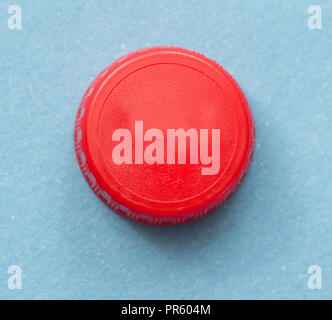 red bottle cap on blue background Stock Photo