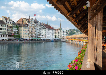 The Kapellbrücke (literally, Chapel Bridge) is a covered wooden footbridge spanning diagonally across the Reuss in the city of Lucerne in central Swit Stock Photo