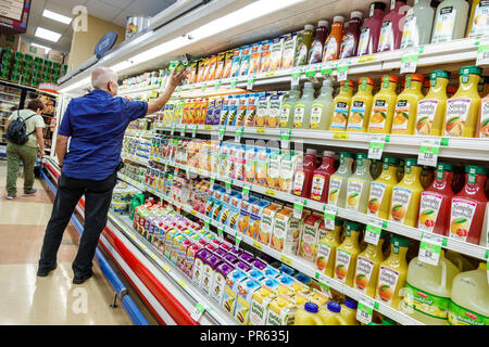 Miami Florida,Little Havana,Sedano's supermarket grocery store food,display sale shelves,juices orange juice senior citizen man male selecting Dole Stock Photo