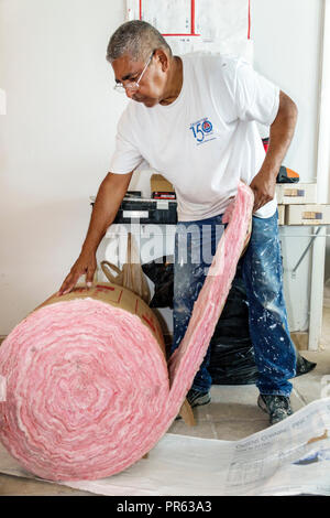 Miami Beach Florida,contractor renovation home remodeling,Hispanic man male senior working installing insulation Stock Photo