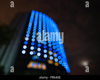 Defocused view of a modern building in Shanghai China with beautiful round blue bokeh effect Stock Photo