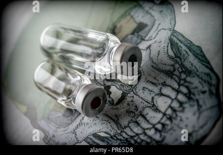 Vials on a skull, conceptual image Stock Photo