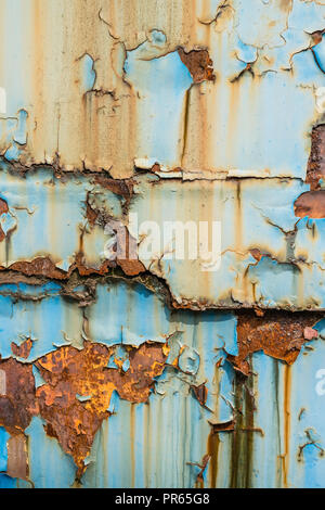 Texture of blue and yellow metal wall with rust and peeling paint, can be used as overlay or texture Stock Photo