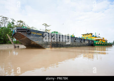 Palm oil tanker at a jetty on the Kinabatangan River in Sabah Borneo being loaded with refined palm oil for export Stock Photo