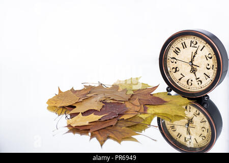 Daylight Saving Time. Wall Clock going to winter time. Autumn abstraction. Fall back time. Stock Photo