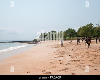 Playing football in Tamarindos Beach, São Tomé Stock Photo