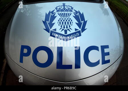 smiling smirking mouth bonnet of police car police Scotland logos logo on hood of police car Stock Photo