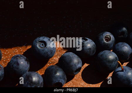 Blueberries bright ripe dark blue on a natural wooden background Stock Photo