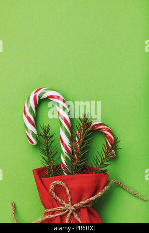 Bag of red color with Christmas gifts on green background with copy space Stock Photo