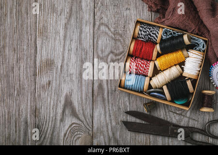 Set of different threads and tools for needlework with copy space, top view Stock Photo