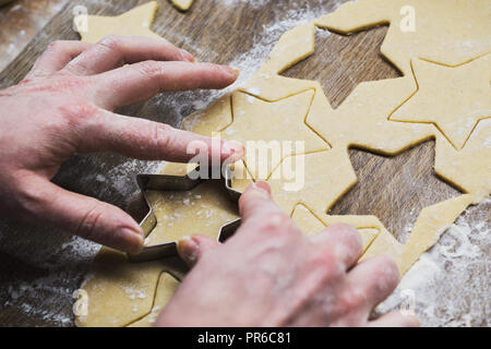 Christmas baking. Woman making gingerbread biscuits. Hand detail. Stock Photo