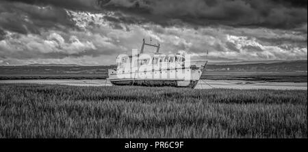 Boat on marshland, Heswall, Wirral, UK. Stock Photo