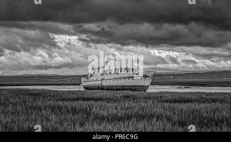 Boat on marshland, Heswall, Wirral, UK. Stock Photo