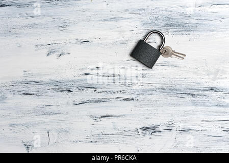 padlock and keys on white, wooden background, top view Stock Photo