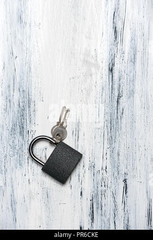 padlock and keys on white, wooden background, top view Stock Photo