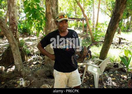 Micronesian man holds a coconut crab, Birgus latro, Ant Atoll, Pohnpei, Federated States of Micronesia Stock Photo