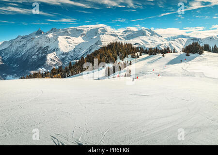 Beautiful sunny winter landscape and snowy mountains with spectacular ski slopes in Alpe d Huez famous ski resort, France, Europe Stock Photo