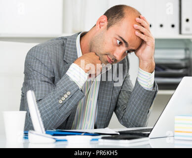 Male having lot of work and problems in the office Stock Photo