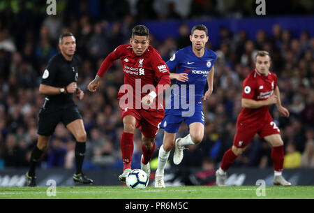 Liverpool's Roberto Firmino (centre left) and Chelsea's Jorginho in action during the Premier League match at Stamford Bridge, London. Stock Photo