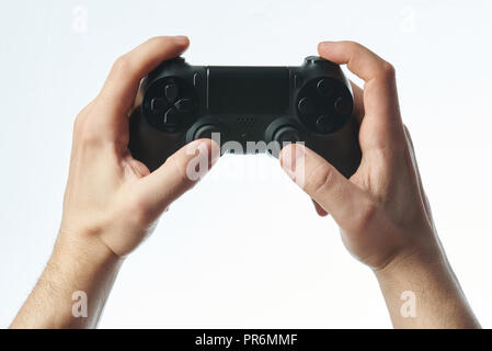 Black joystick in hands isolated on white background Stock Photo