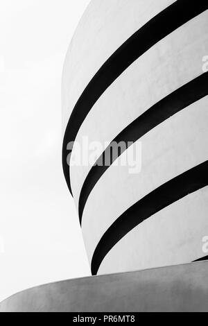 High contrast black and white photograph of Solomon R. Guggenheim Museum on the Upper East Side of Manhattan, New York City. Designed by Frank Lloyd W
