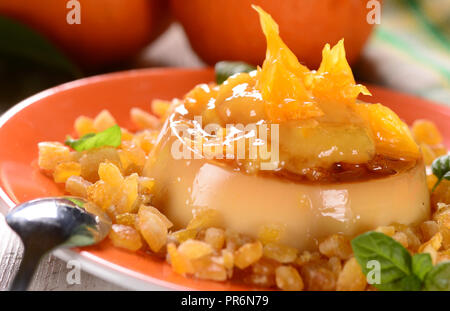 Italian dessert panna cotta with orange sauce Stock Photo