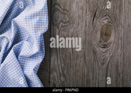 Top view of blue tablecloth located on left side of wooden table. Food  background Stock Photo