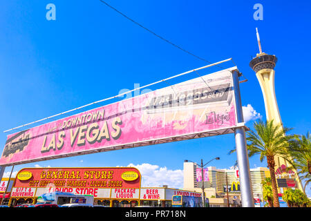 Las Vegas, Nevada, USA - August 18, 2018: closeup of Welcome to Downtown Las Vegas Sign in Fremont Street Las Vegas Boulevard with Stratosphere Casino, Hotel and Tower on background. Blue sky. Stock Photo