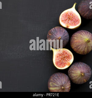 Fresh figs on dark surface, overhead view. From above, top view. Space for text. Stock Photo