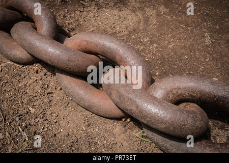 big rusty chain on floor closeup  - anchor chain - Stock Photo