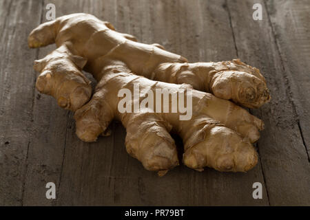 Fresh raw organic ginger root on a wooden background Stock Photo