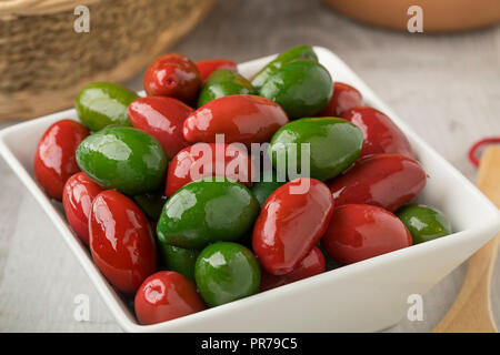Bowl with red and green Italan bella di cerignola olives Stock Photo