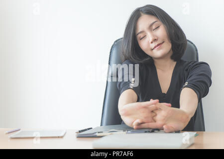 Happy business woman is relaxing and stretching out in office Stock Photo