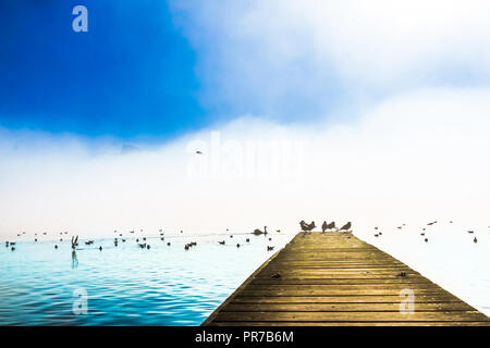 View on morning fog on Pier of lake Mondsee in Austria Stock Photo