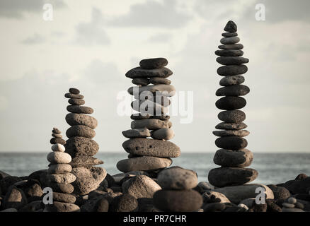 Balanced stones/stone stacking on rocky beach. Stock Photo