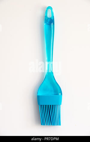 Blue plastic and silicon basting brush on a white background Stock Photo