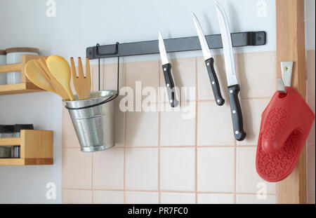 Knives on magnetic rack in commercial kitchen Stock Photo by Mint_Images