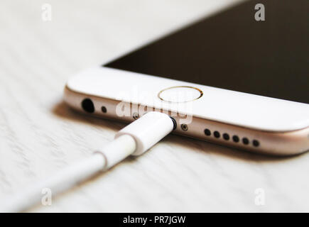 Close up charging smartphone. White Iphone 6 charge Stock Photo