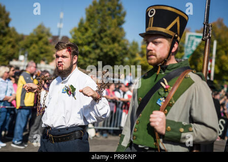 Stuttgart, Germany. 30 September 2018. In historical costumes and disguises, participants of the 200th anniversary procession of the Cannstatter Volksfest run through the Cannstatter Wasen. Credit: dpa picture alliance/Alamy Live News Stock Photo