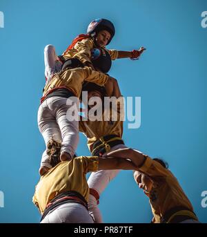 Torredembarra, Spain. 30 September, 2018:  The 'Castellers de Badalona' build a human tower during the first day of the 27th Tarragona Human Tower Competition in Torredembarra. The competition takes place every other year and features the main 'Castellers' teams (colles) of Catalonia during a three day event organized by the Tarragona City Hall Credit: Matthias Oesterle/Alamy Live News Stock Photo