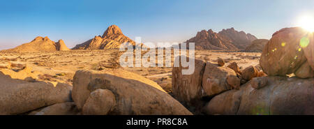 Panoramic view of the ancient Spitzkoppe region of Damaraland, Namibia, with its massive boulders, rocky hills and mountains in early morning light. Stock Photo