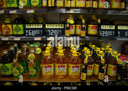 Cooking oils for sale in a grocery shop, Haikou, Hainan Island, China Stock Photo